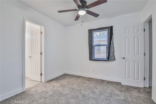 9218 Hooper Ave, Los Angeles, CA 90002 - unfurnished bedroom with carpet floors and ceiling fan
