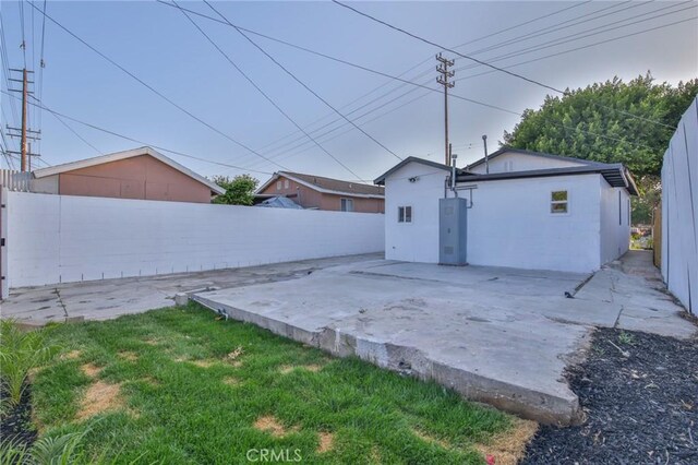 9218 Hooper Ave, Los Angeles, CA 90002 - fenced backyard featuring a patio area and an outbuilding