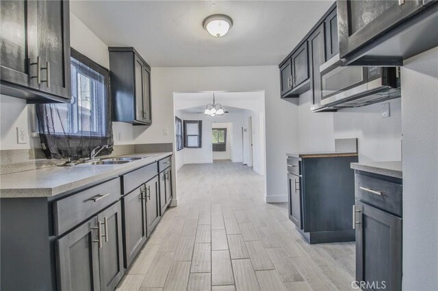 9218 Hooper Ave, Los Angeles, CA 90002 - kitchen with a chandelier, light wood-type flooring, and light countertops