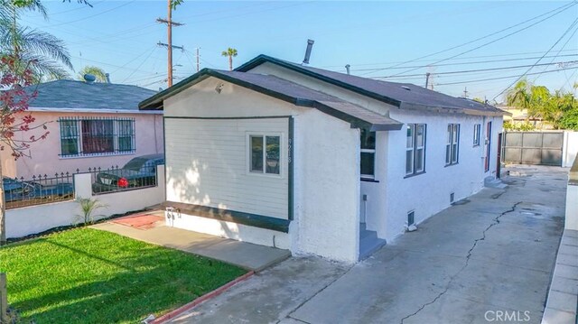 9218 Hooper Ave, Los Angeles, CA 90002 - view of home's exterior featuring stucco siding and a patio area