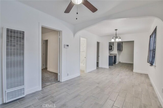 9218 Hooper Ave, Los Angeles, CA 90002 - unfurnished living room with a heating unit, ceiling fan, light wood-type flooring, and a chandelier