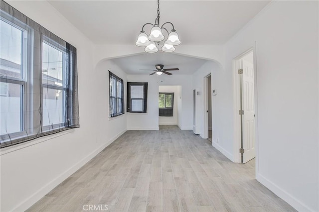9218 Hooper Ave, Los Angeles, CA 90002 - hall with a chandelier, arched walkways, and light wood finished floors