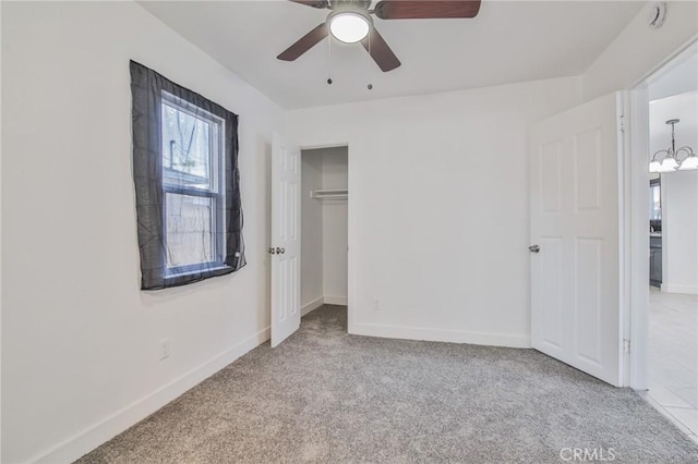 9218 Hooper Ave, Los Angeles, CA 90002 - unfurnished bedroom with carpet floors, multiple windows, a closet, and a chandelier