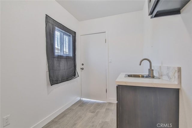9218 Hooper Ave, Los Angeles, CA 90002 - washroom featuring a sink and light wood-style floors
