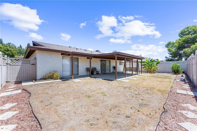 17300 Azalea Ct, La Puente, CA 91744 - back of property with a patio area, a fenced backyard, stucco siding, and a gate