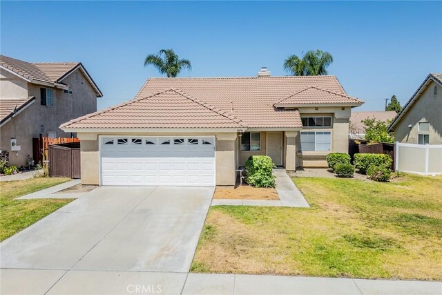 1870 S Jasmin Ct, Loma Linda, CA 92354 - view of front of house featuring a tiled roof, stucco siding, a garage, concrete driveway, and a chimney