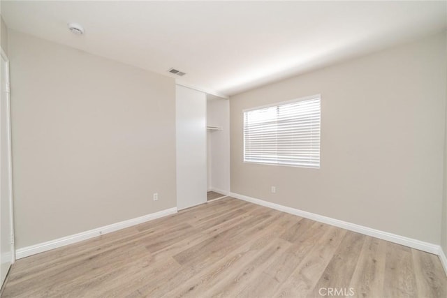 1870 S Jasmin Ct, Loma Linda, CA 92354 - spare room with light wood-style floors and a smoke detector