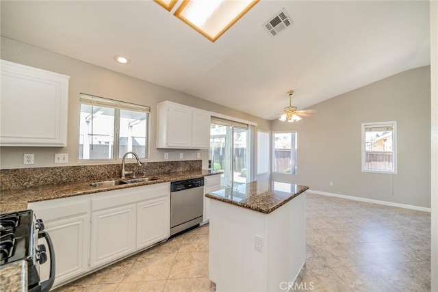 1870 S Jasmin Ct, Loma Linda, CA 92354 - kitchen featuring stainless steel dishwasher, lofted ceiling, black gas range, dark stone countertops, and white cabinets