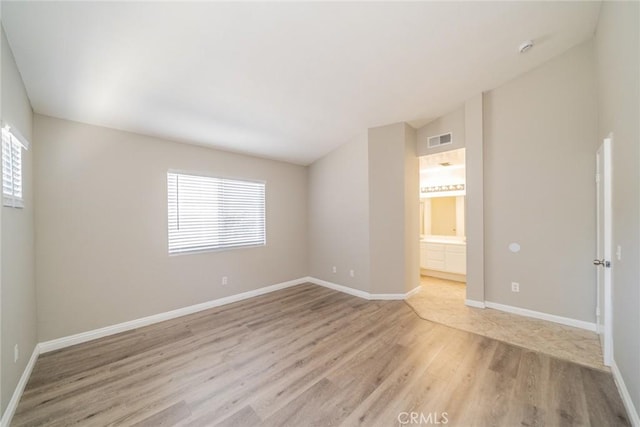 1870 S Jasmin Ct, Loma Linda, CA 92354 - unfurnished room featuring light wood-style floors, plenty of natural light, and a smoke detector