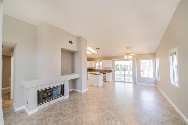 1870 S Jasmin Ct, Loma Linda, CA 92354 - unfurnished living room with a ceiling fan and a tiled fireplace