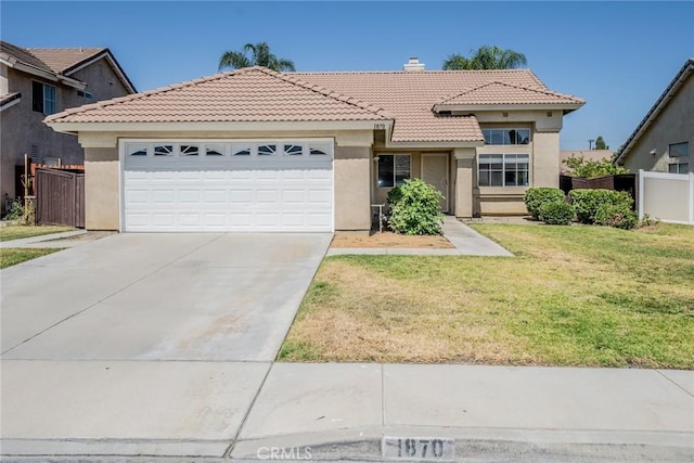 1870 S Jasmin Ct, Loma Linda, CA 92354 - mediterranean / spanish-style house with a tile roof, stucco siding, concrete driveway, a garage, and a chimney
