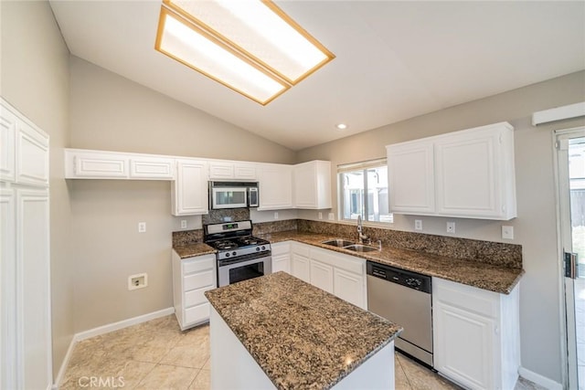 1870 S Jasmin Ct, Loma Linda, CA 92354 - kitchen with appliances with stainless steel finishes, lofted ceiling, a center island, white cabinets, and dark stone counters