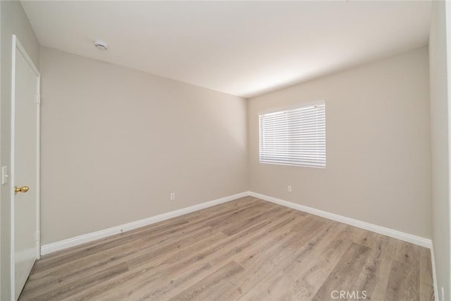 1870 S Jasmin Ct, Loma Linda, CA 92354 - empty room with light wood-style flooring and a smoke detector