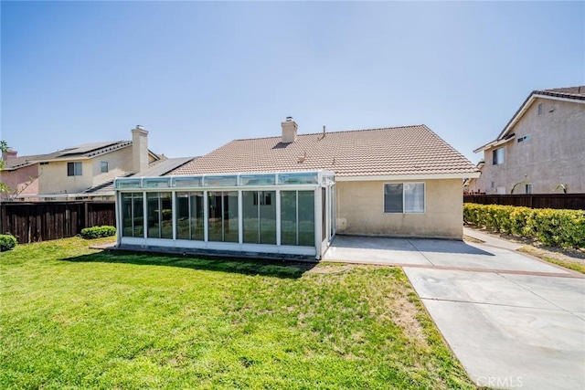 1870 S Jasmin Ct, Loma Linda, CA 92354 - back of house with a tiled roof, a fenced backyard, a sunroom, a chimney, and stucco siding