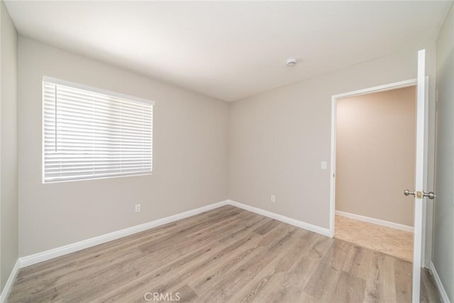1870 S Jasmin Ct, Loma Linda, CA 92354 - spare room featuring light wood finished floors and a smoke detector
