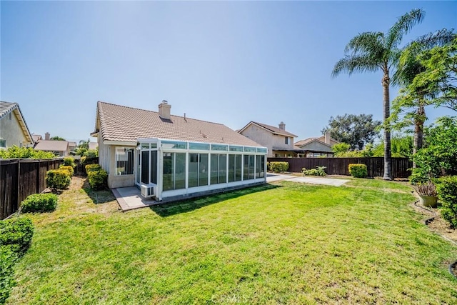 1870 S Jasmin Ct, Loma Linda, CA 92354 - back of property with a sunroom, a fenced backyard, a tiled roof, a chimney, and a patio area