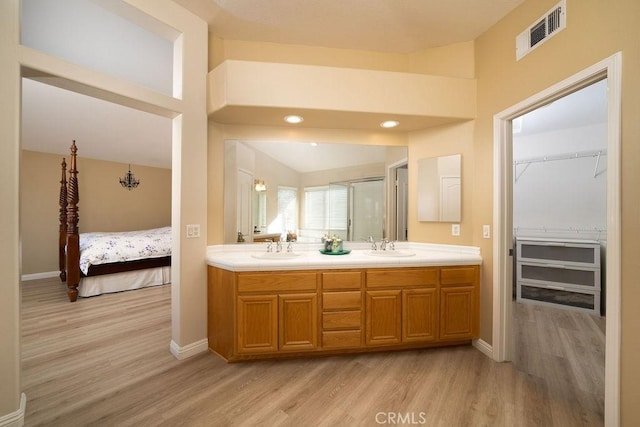 27829 Coldsprings Pl, Valencia, CA 91354 - full bathroom featuring wood finished floors, double vanity, a spacious closet, an enclosed shower, and recessed lighting