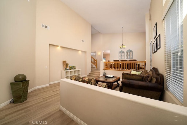 27829 Coldsprings Pl, Valencia, CA 91354 - living room with light wood-style floors, stairway, a towering ceiling, and a chandelier