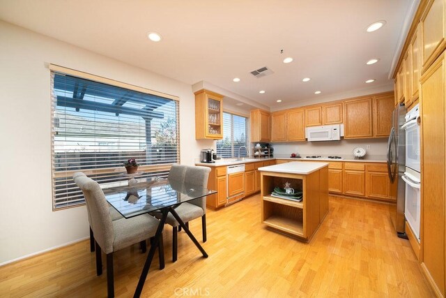 27829 Coldsprings Pl, Valencia, CA 91354 - kitchen featuring white appliances, light wood finished floors, a center island, light countertops, and recessed lighting