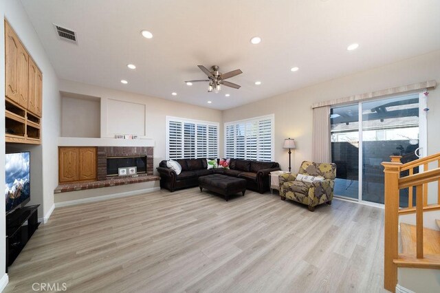 27829 Coldsprings Pl, Valencia, CA 91354 - living room featuring ceiling fan, recessed lighting, light wood-style flooring, and a brick fireplace