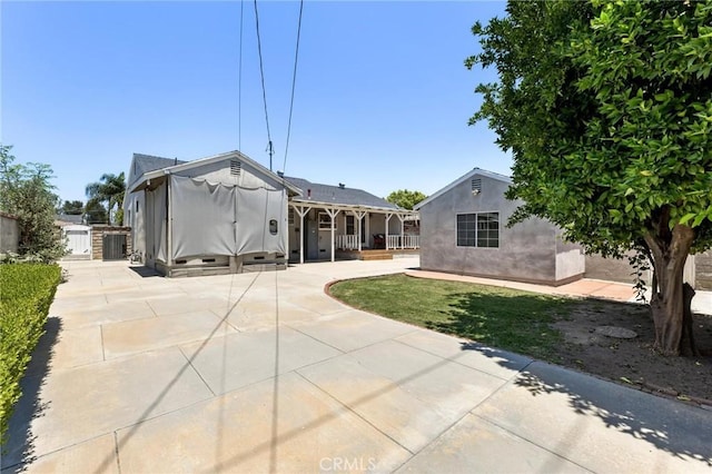 16728 Los Alimos St, Granada Hills, CA 91344 - back of property featuring a gate, a patio, and stucco siding