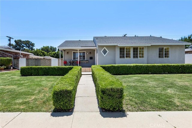 16728 Los Alimos St, Granada Hills, CA 91344 - view of front of house featuring a front lawn and stucco siding
