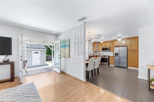 16728 Los Alimos St, Granada Hills, CA 91344 - foyer with a chandelier and dark wood-style floors