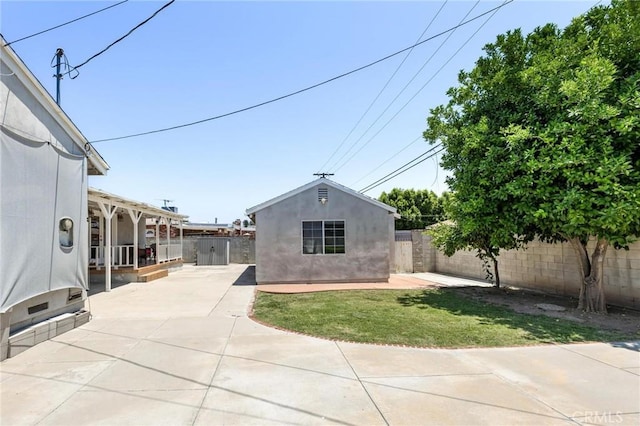 16728 Los Alimos St, Granada Hills, CA 91344 - exterior space with a patio area, a fenced backyard, an outbuilding, and stucco siding