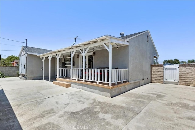 16728 Los Alimos St, Granada Hills, CA 91344 - view of front of home with covered porch, stucco siding, and a gate
