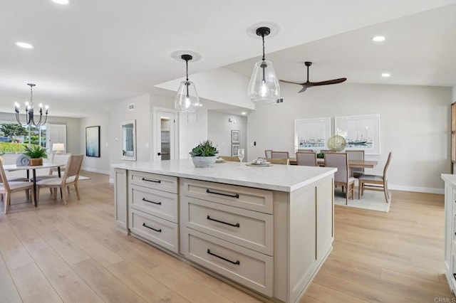 1358 Walnutview Dr, Encinitas, CA 92024 - kitchen featuring hanging light fixtures, a ceiling fan, light wood-style flooring, a center island, and a chandelier