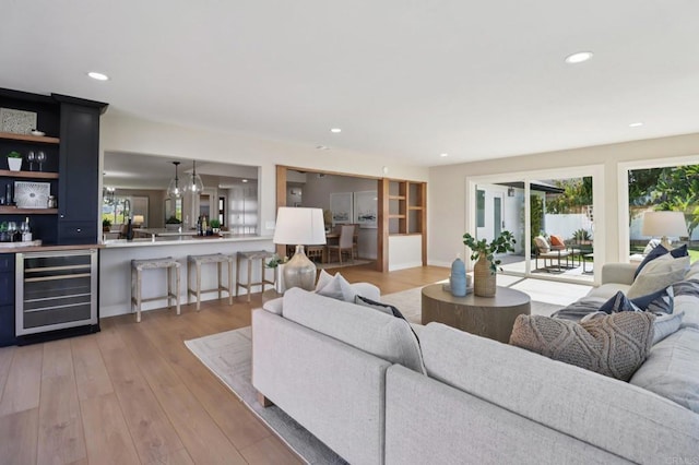 1358 Walnutview Dr, Encinitas, CA 92024 - living room featuring beverage cooler, light wood-style flooring, recessed lighting, bar area, and a chandelier