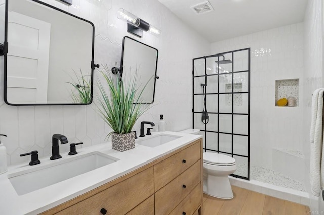 1358 Walnutview Dr, Encinitas, CA 92024 - full bath with double vanity, walk in shower, wood finished floors, and decorative backsplash