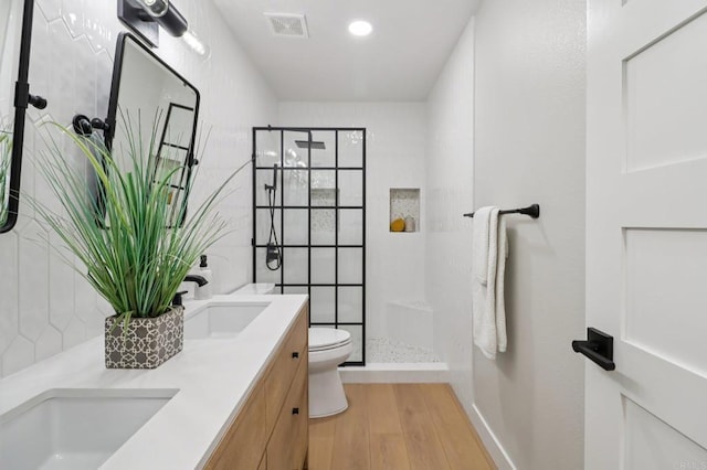 1358 Walnutview Dr, Encinitas, CA 92024 - bathroom with wood finished floors, double vanity, tiled shower, and recessed lighting