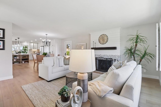 1358 Walnutview Dr, Encinitas, CA 92024 - living room featuring a chandelier, light wood finished floors, a fireplace, and recessed lighting