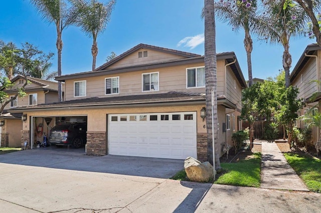 8980 Lamar St # 6, Spring Valley, CA 91977 - view of front of house with a garage, stone siding, and driveway