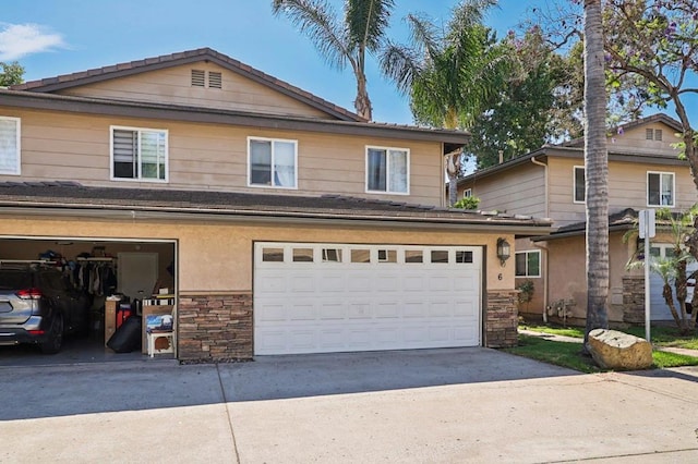 8980 Lamar St # 6, Spring Valley, CA 91977 - view of front of home with stone siding, driveway, and a garage