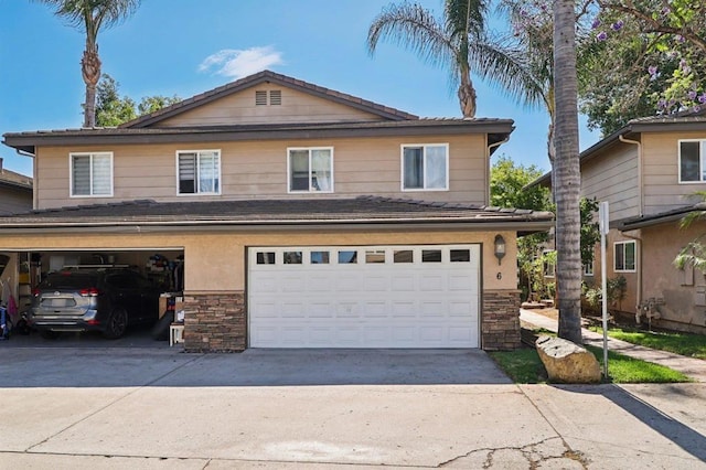 8980 Lamar St # 6, Spring Valley, CA 91977 - view of front of house featuring stone siding, driveway, and a garage