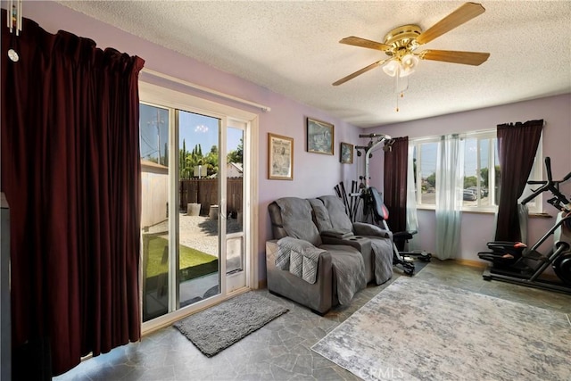 341 Mellane Cir, Orland, CA 95963 - living room featuring a textured ceiling, healthy amount of natural light, a ceiling fan, and stone finish flooring
