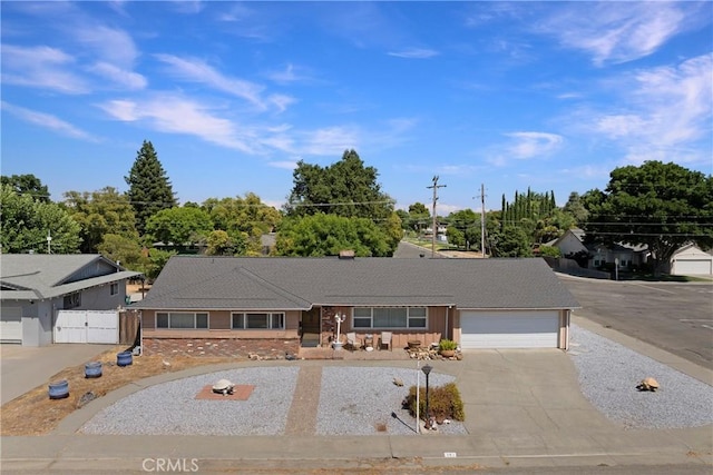 341 Mellane Cir, Orland, CA 95963 - ranch-style home with driveway, an attached garage, and a gate