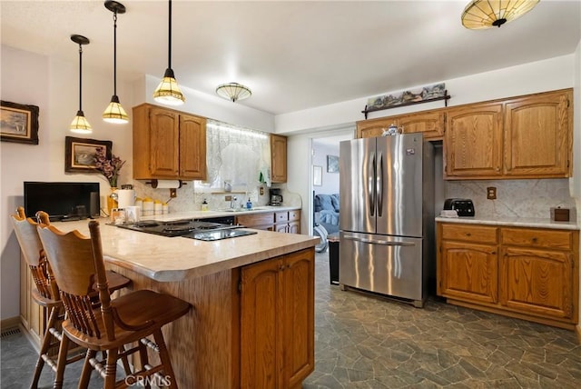 341 Mellane Cir, Orland, CA 95963 - kitchen featuring freestanding refrigerator, a peninsula, light countertops, and backsplash