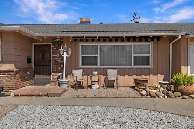 341 Mellane Cir, Orland, CA 95963 - property entrance featuring a shingled roof, board and batten siding, and a chimney