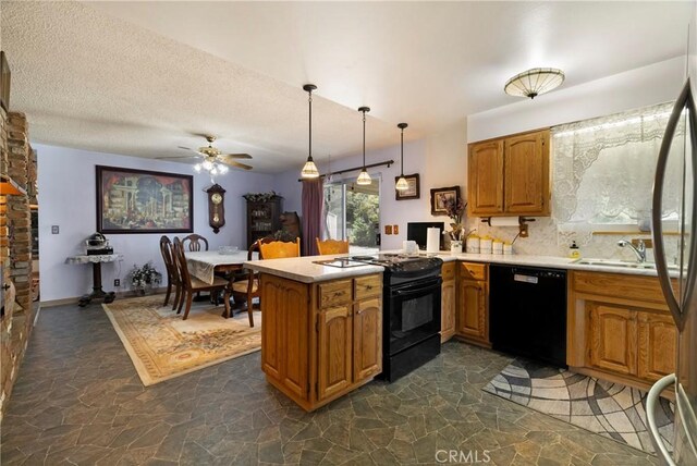 341 Mellane Cir, Orland, CA 95963 - kitchen with black appliances, stone floors, brown cabinetry, a ceiling fan, and a peninsula