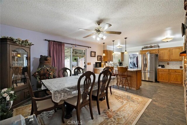 341 Mellane Cir, Orland, CA 95963 - dining space featuring dark stone finish flooring, a textured ceiling, and ceiling fan