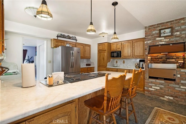 341 Mellane Cir, Orland, CA 95963 - kitchen with black appliances, tasteful backsplash, brown cabinets, light countertops, and a breakfast bar