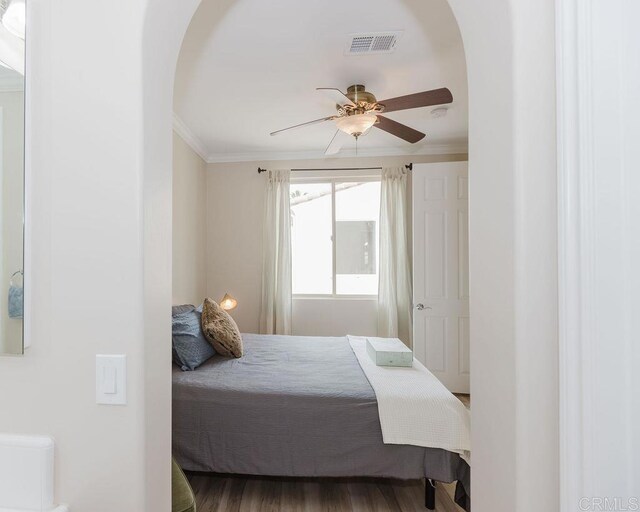 2740 E Bainbridge Rd, San Diego, CA 92106 - bedroom with arched walkways, crown molding, a ceiling fan, and wood finished floors
