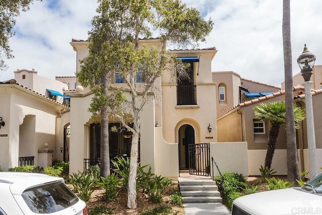 2740 E Bainbridge Rd, San Diego, CA 92106 - mediterranean / spanish-style house with stucco siding, a gate, and a tiled roof