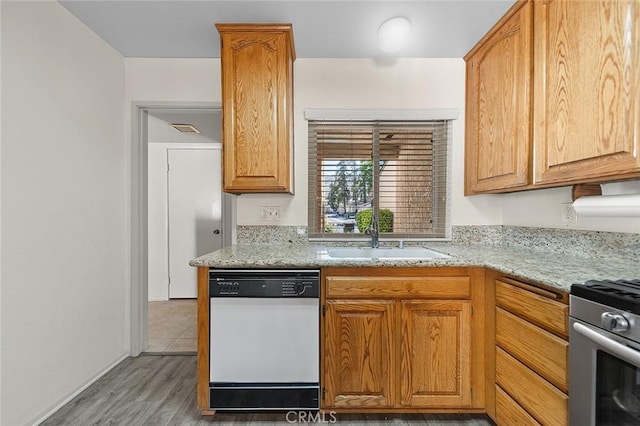 834 E Pepper Tree Dr, Azusa, CA 91702 - kitchen featuring white dishwasher, stainless steel range with gas stovetop, light wood-style floors, and light stone countertops