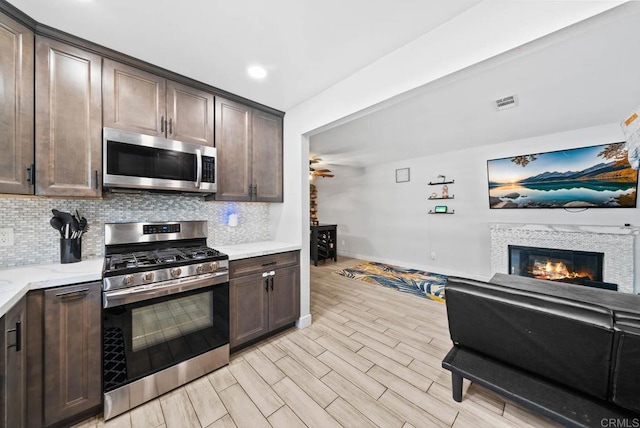 353 61st St, San Diego, CA 92114 - kitchen featuring stainless steel appliances, dark brown cabinetry, a ceiling fan, decorative backsplash, and recessed lighting