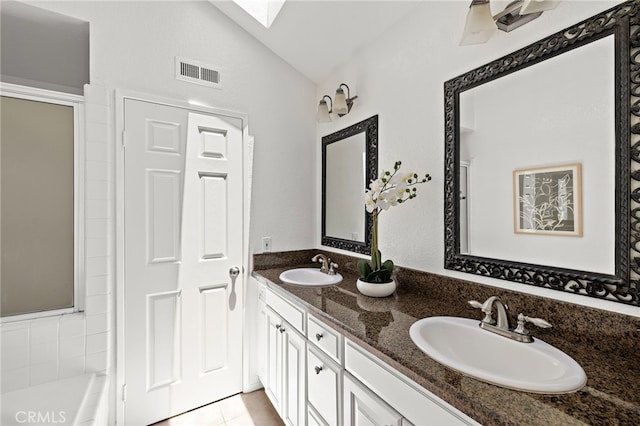 18 Saint Thomas, Laguna Niguel, CA 92677 - bathroom with lofted ceiling, double vanity, a skylight, a bathtub, and an enclosed shower