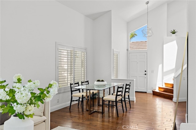 18 Saint Thomas, Laguna Niguel, CA 92677 - dining area featuring a towering ceiling, hardwood / wood-style floors, stairway, and a chandelier